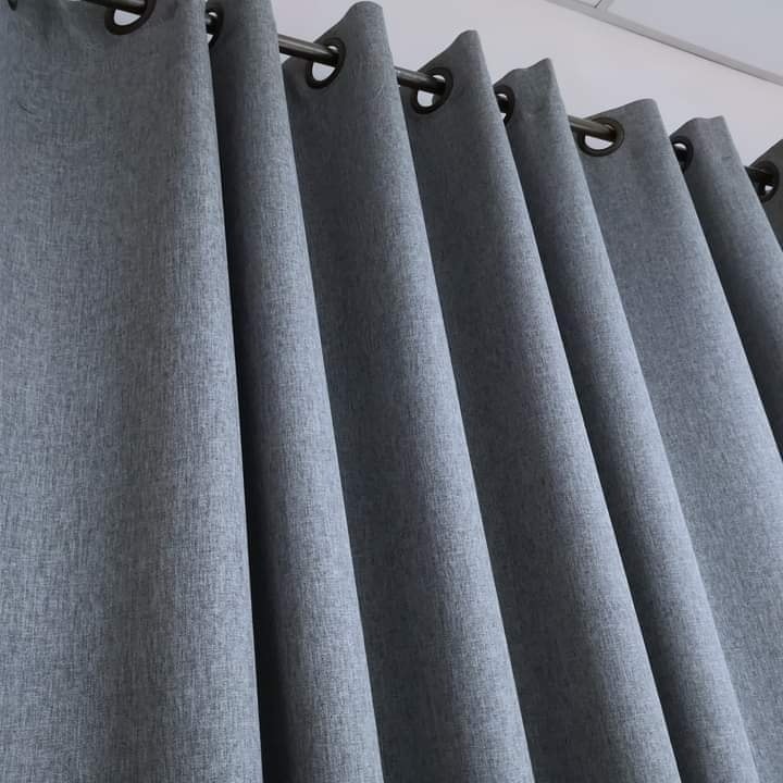 Eyelet Blackout curtains with black color rods and black curtain ring by curtains shop dubai