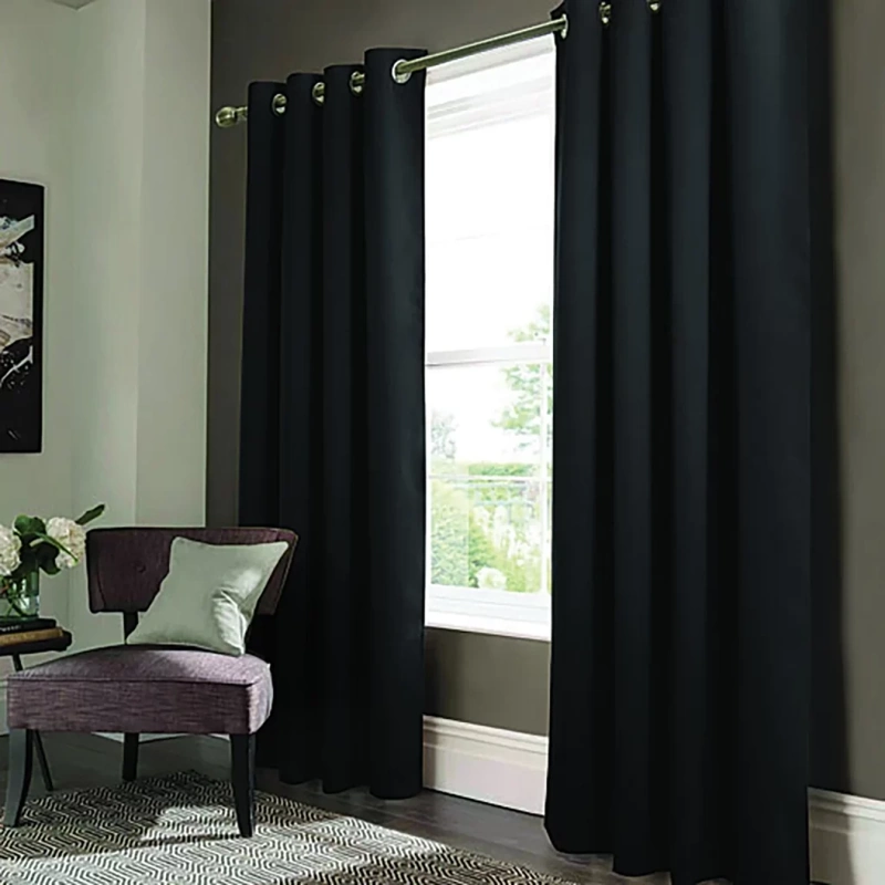 Stylish black blackout curtains with silver grommets, creating a modern and sophisticated look