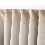 curtains are a light beige color and appear to be made of a thick, woven fabric