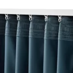 dark blue thermal blackout curtains hanging from a curtain rods in living room area