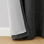 dark gray blackout curtain showcasing the thick, textured fabric and the light-colored backing for maximum light blockage