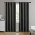 dark gray blackout curtains hanging on a window, blocking out sunlight