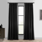 dark, heavy curtains hanging on a window. They appear to be blackout curtains, designed to block out light