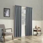 gray thermal blackout curtains hang on a rod in a living room setting