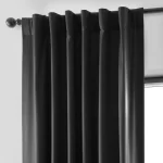 pleated blackout curtain with rod pocket hanging on a curtain rod